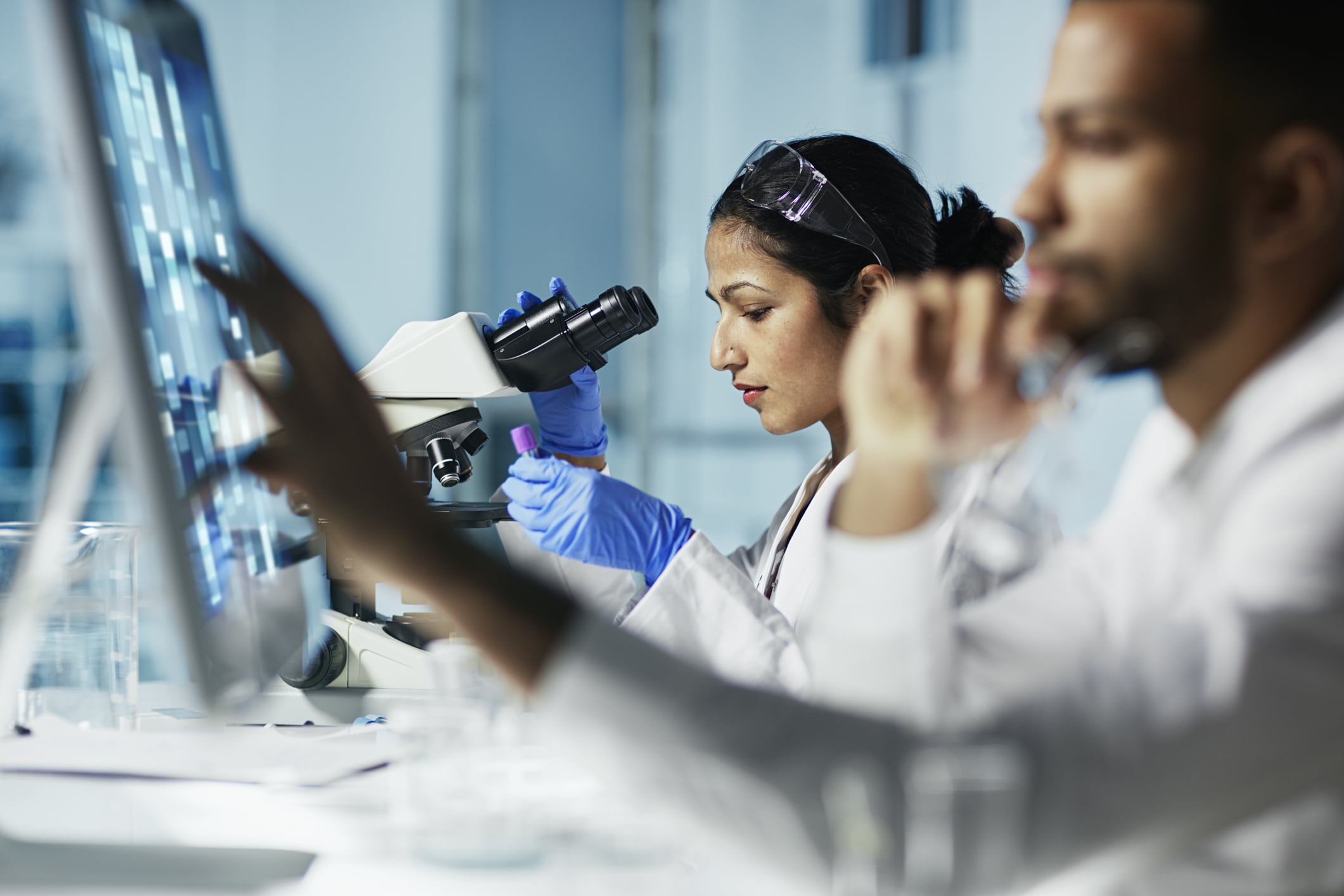 woman looking through a microscope