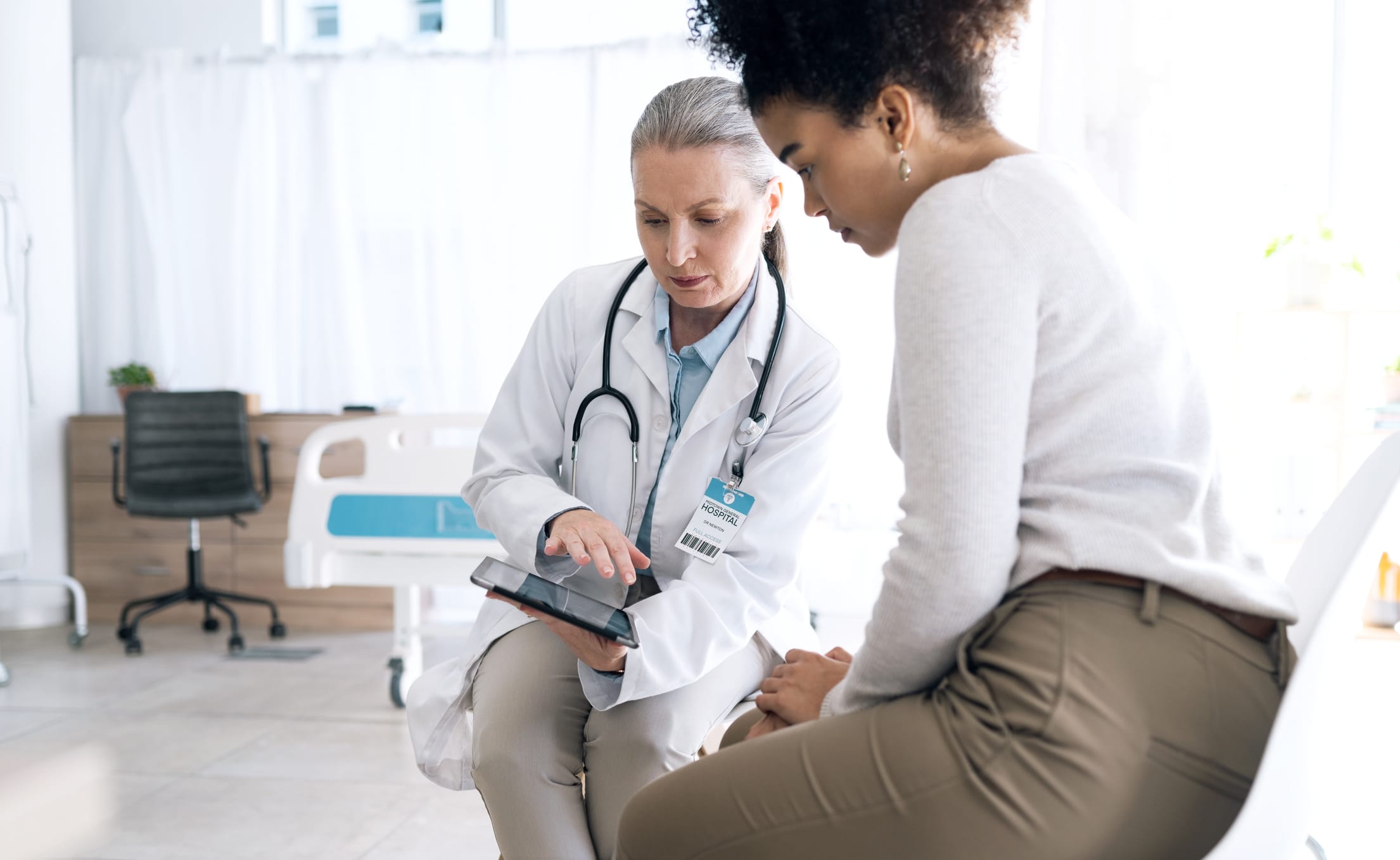 doctor showing patient something on her tablet