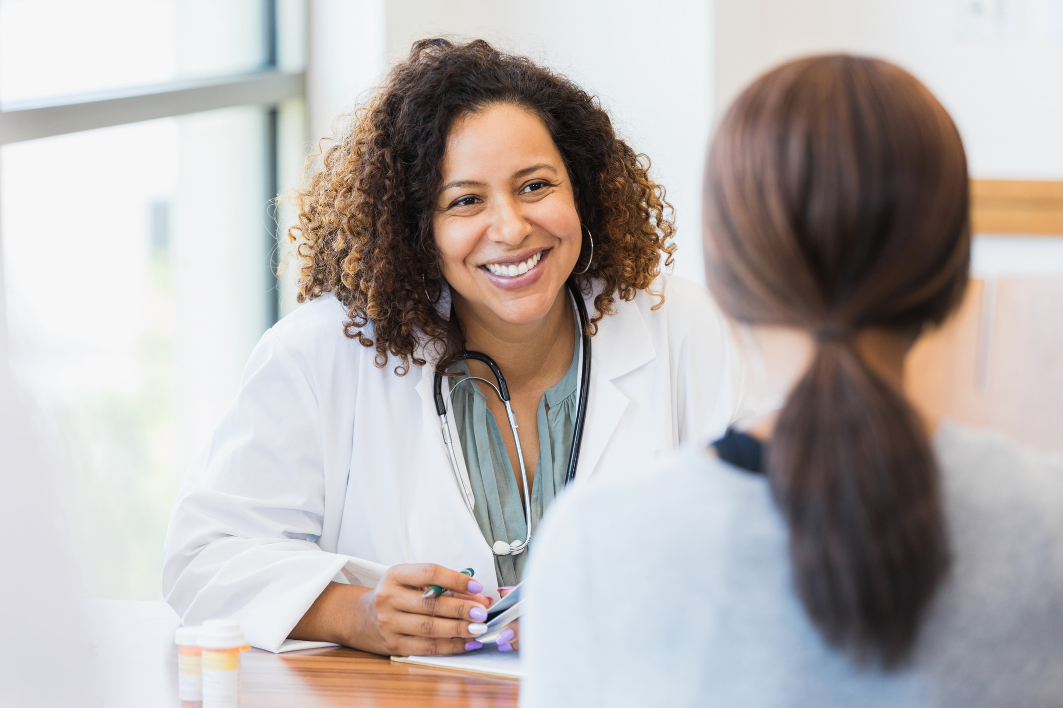 doctor talking to patient happily