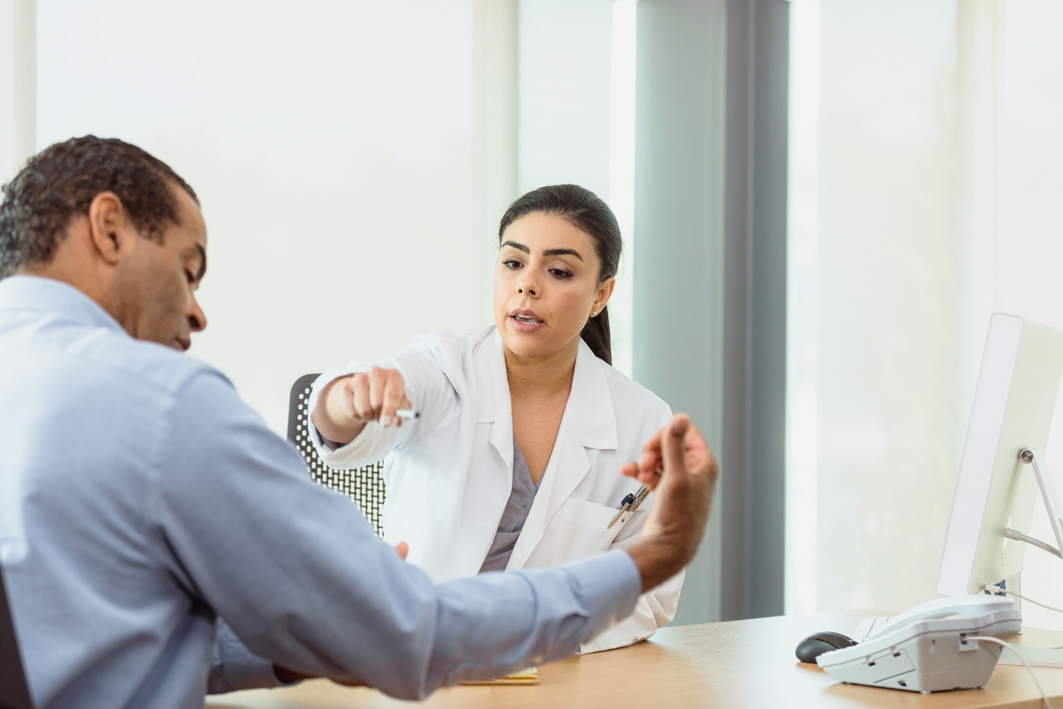 doctor pointing to patient's arm