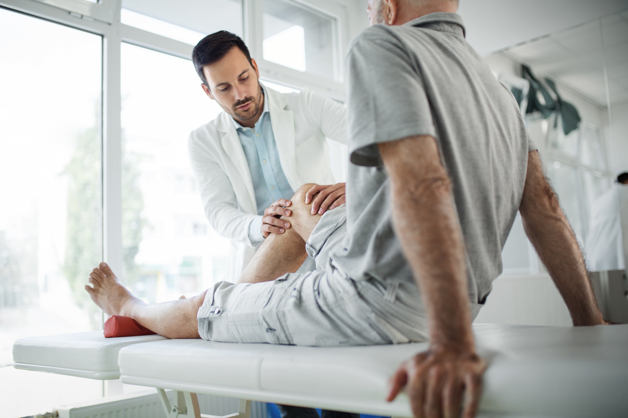 doctor touching patient's knee