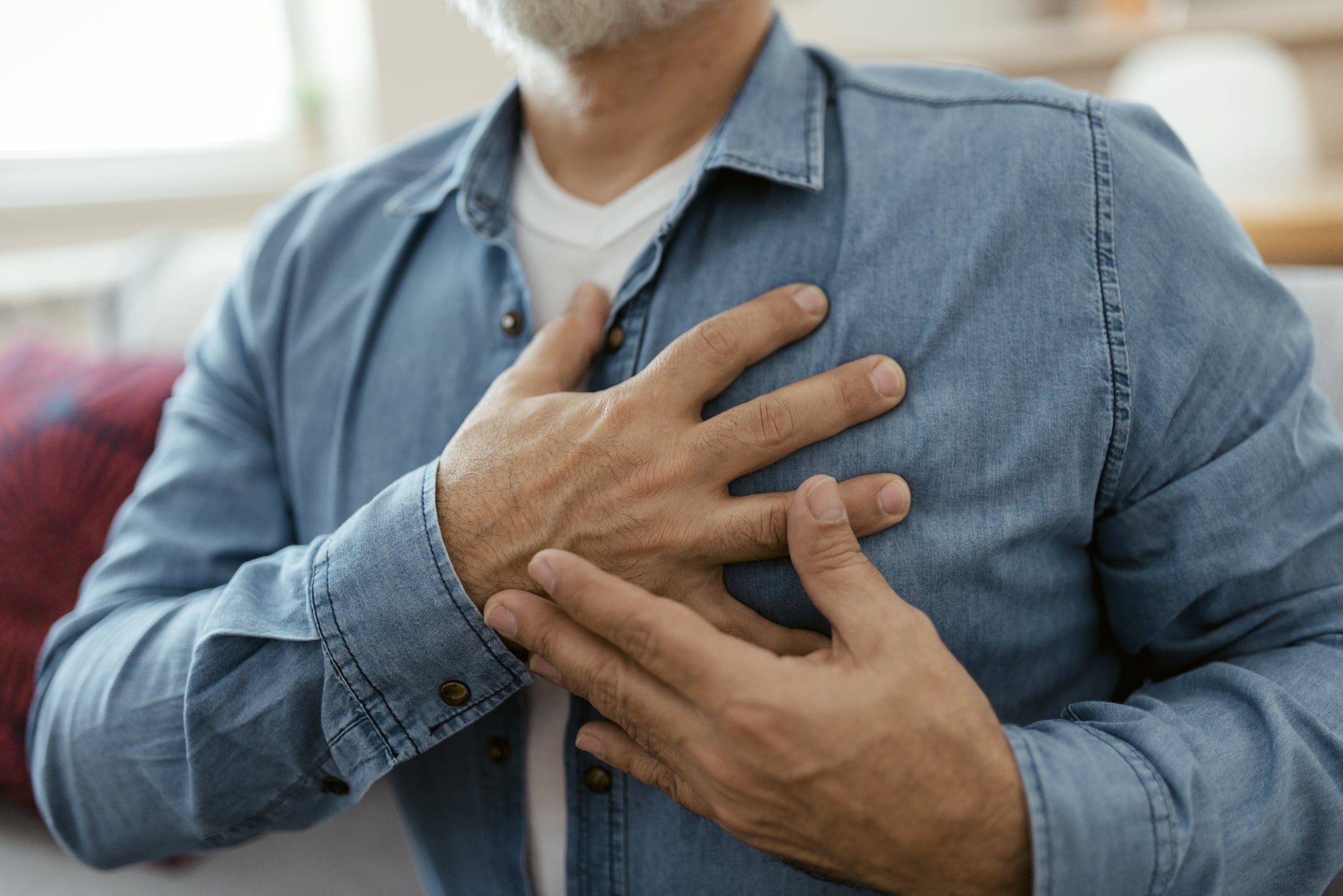man grabbing his chest